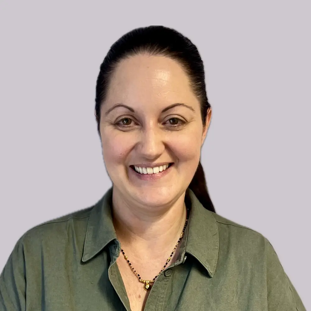 Woman smiling in a green olive shirt